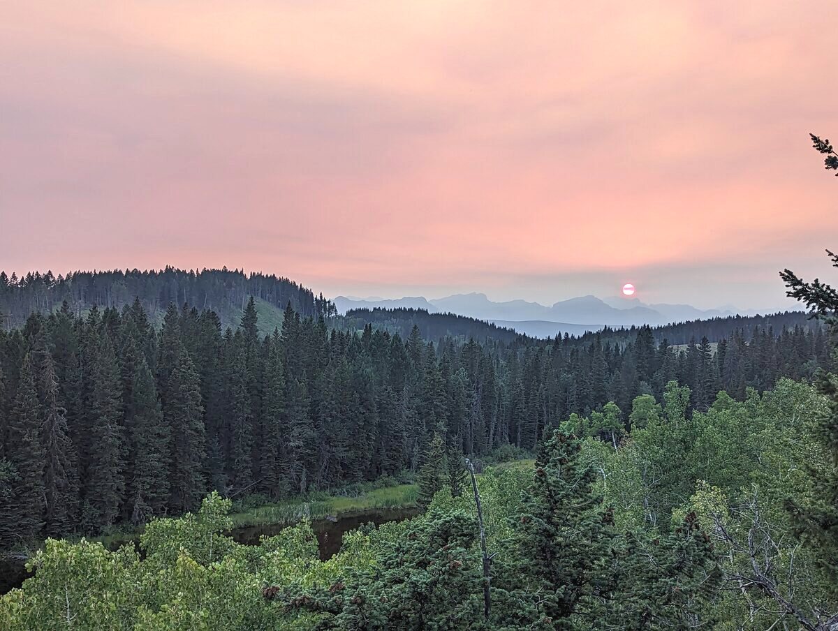 Sunset over the forested foothills near the ranch